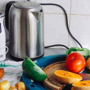 Gray Metal Electric Kettle Near Sliced Vegetables