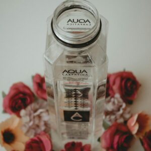 Aqua Bottle Surrounded by Flowers