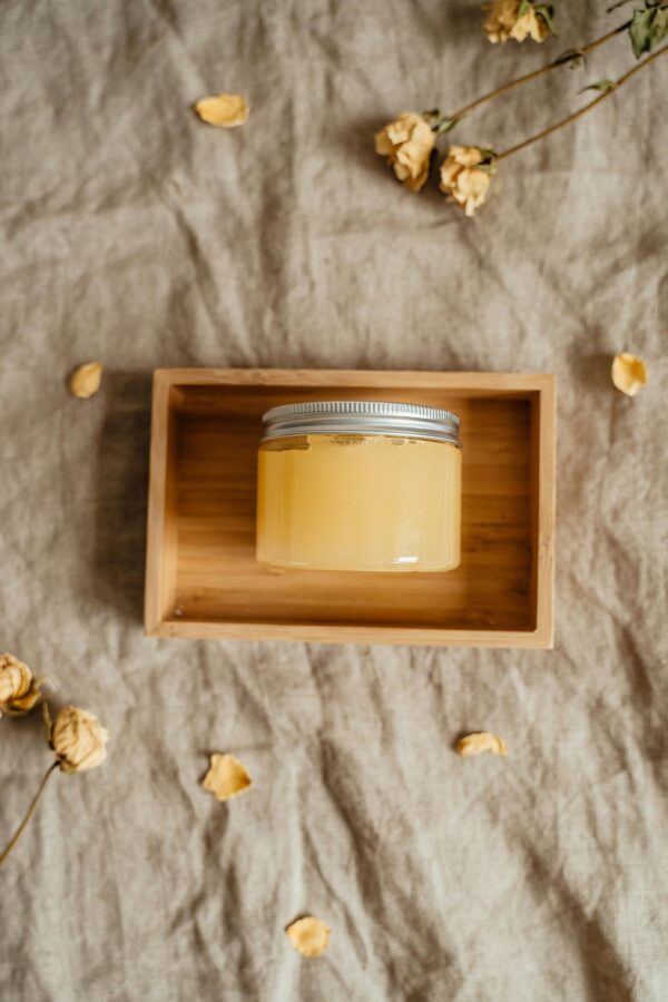 Glass Jar of Yellow Cosmetic Balm in a Wooden Box