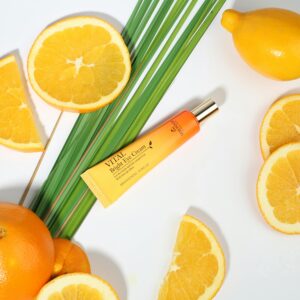 Tube with Eye Cream with Vitamin C and Orange Slices Lying Around